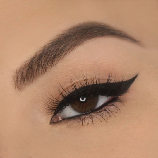 Extreme closeup shot of an eye wearing Vasanti Cleopatra Black Liquid Eyeliner